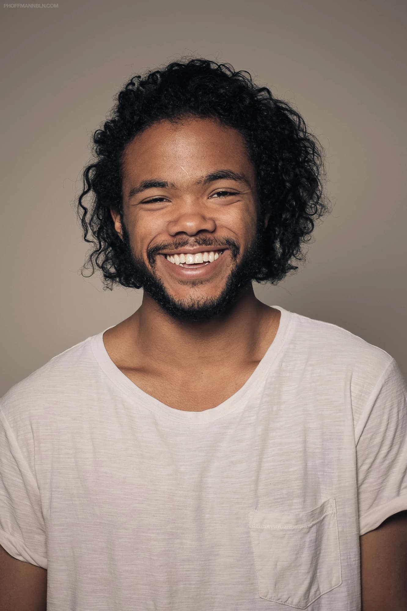 Felix smiling in a portrait photograph used as source material for a personal CoCreate story