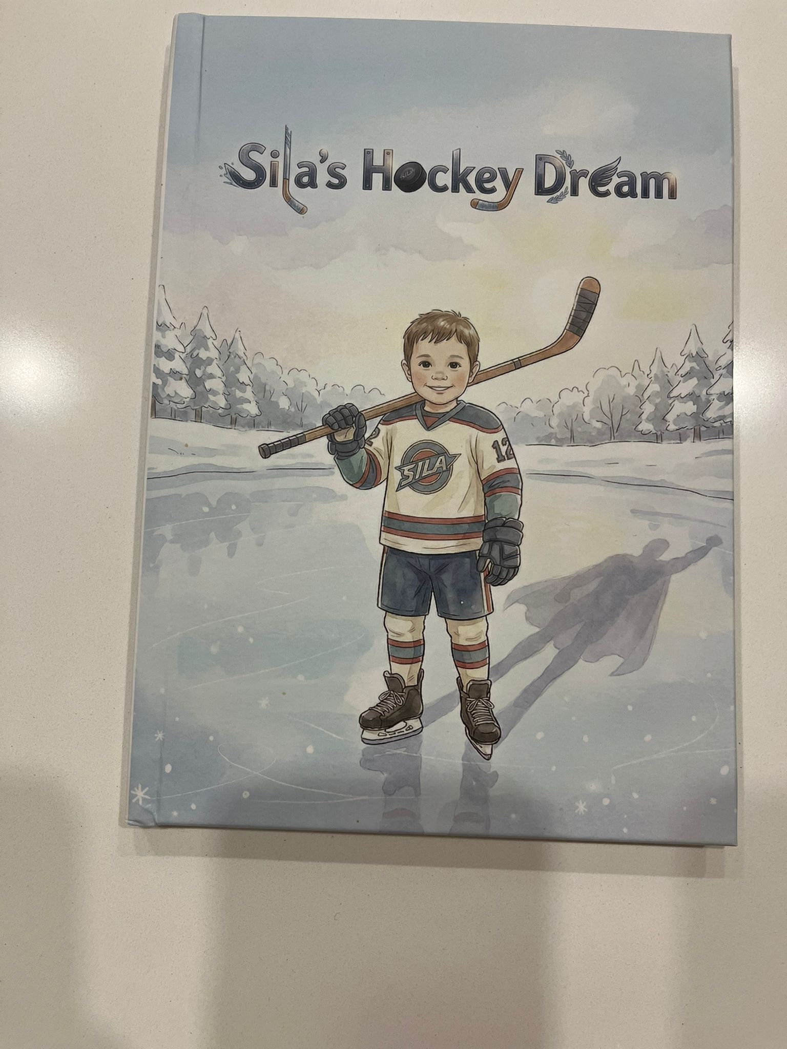 Product photograph: the printed hardcover of Sila’s Hockey Dream on a table